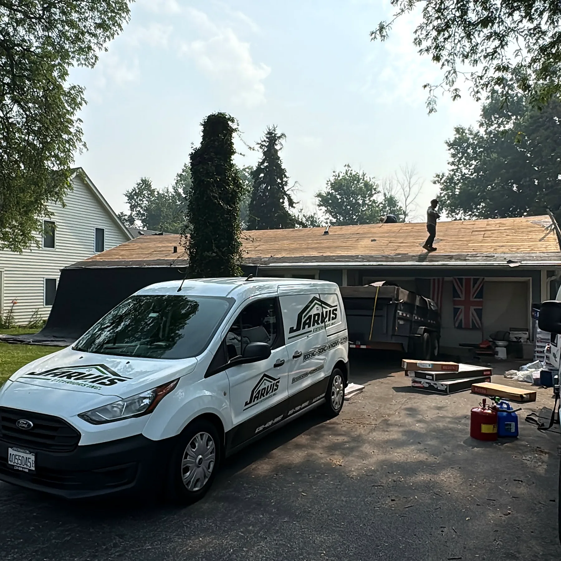 Jarvis Exteriors roofing crew working on a residential roof replacement